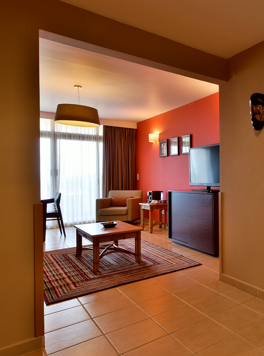 The Suite at Pestana Tropico features a living room with television and a bathroom