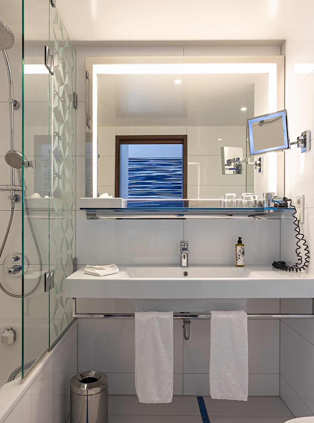 Premium Room with Balcony at Pestana Berlin Tiergarten has a bathroom with shower, a sink and a mirror