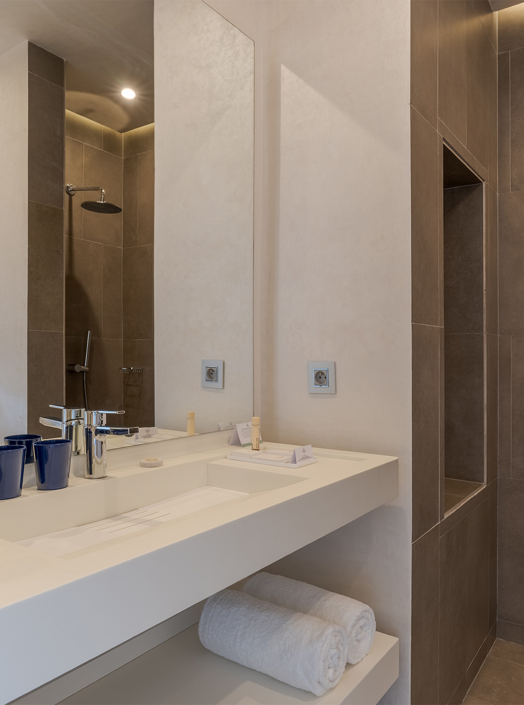 The CR7 Suite at Pestana CR7 Marrakech has a bathroom with a walk-in shower and a sink with a large mirror