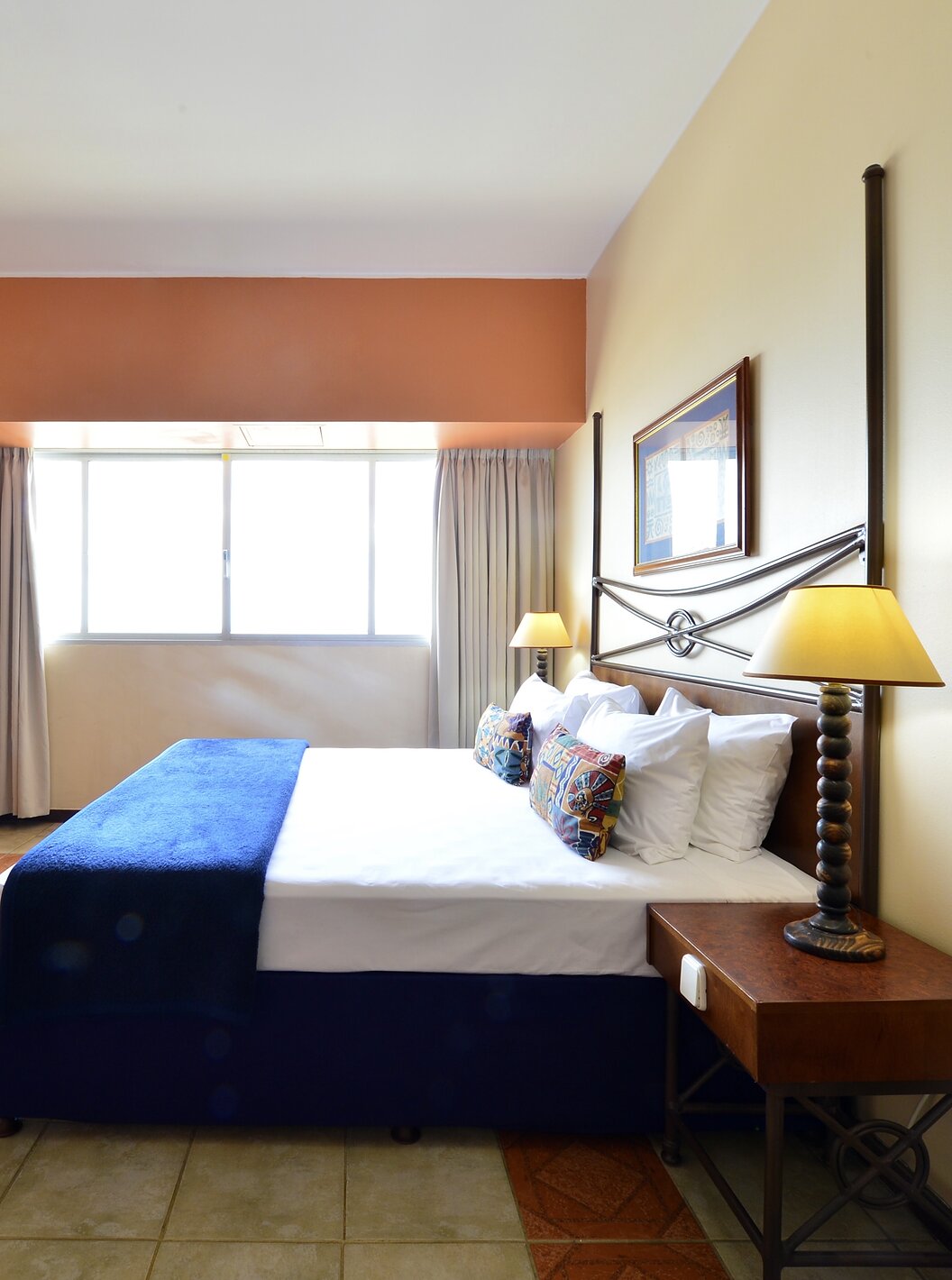 The Executive Suite of Pestana Rovuma has a double bed, desk with television, and a large window