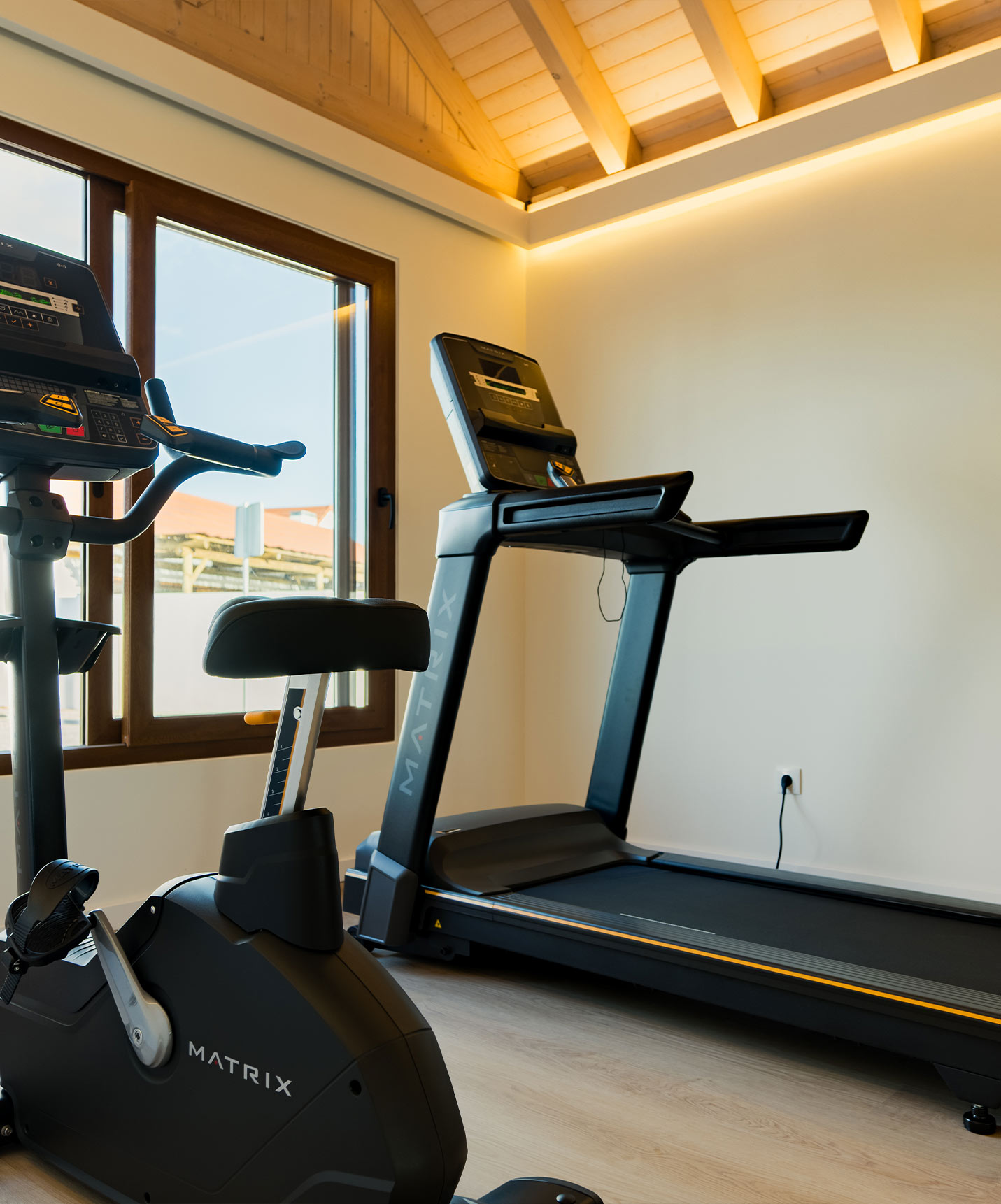 Gym equipped with a treadmill and a bike, located in the villas at Pestana Comporta Village Residences