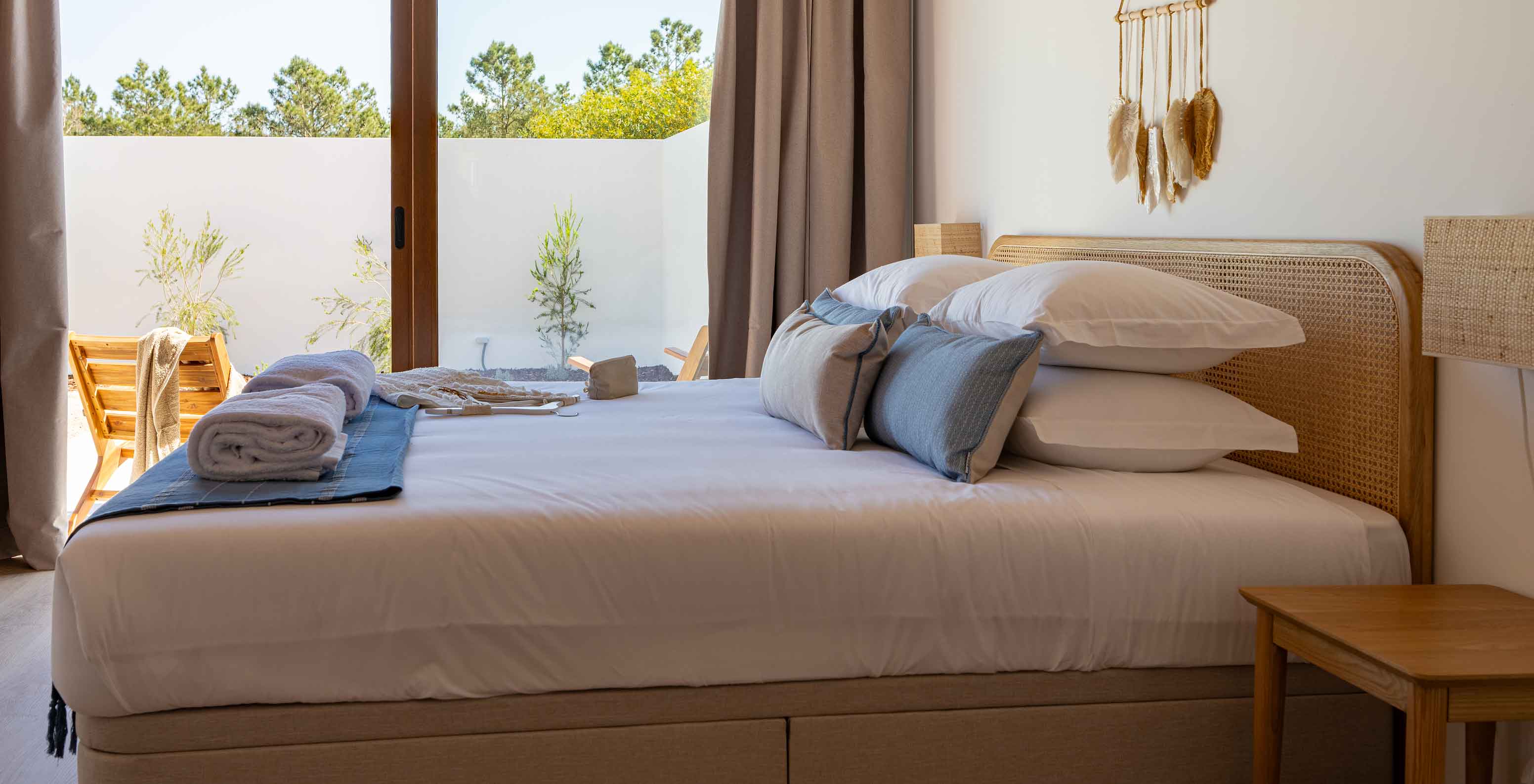 The Premium Green Villa at Pestana Comporta Village Residences has a bedroom with a double bed and a large window