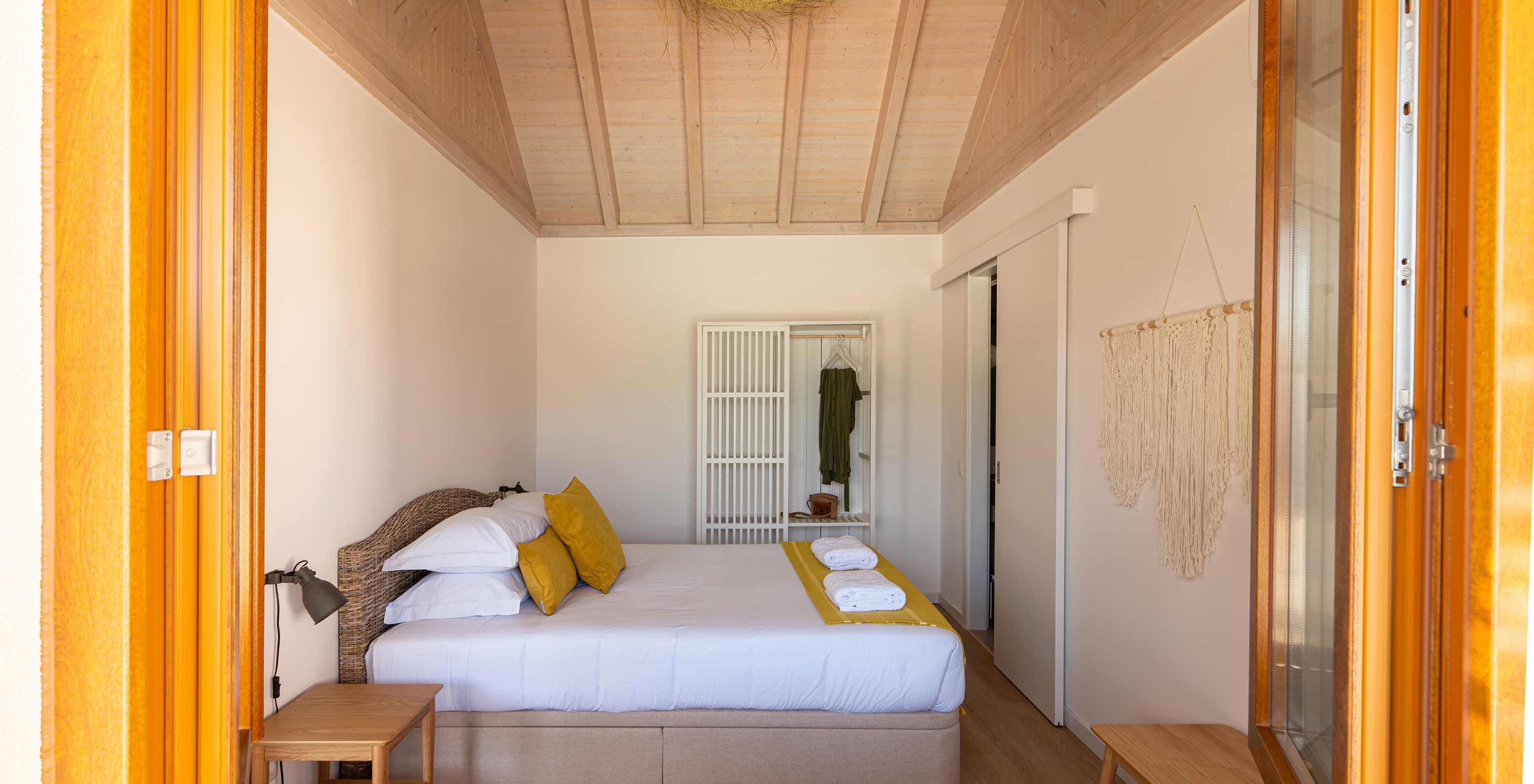 The Premium Villa at Pestana Comporta Village Residences has a bedroom with a double bed, pillows, and a white wardrobe