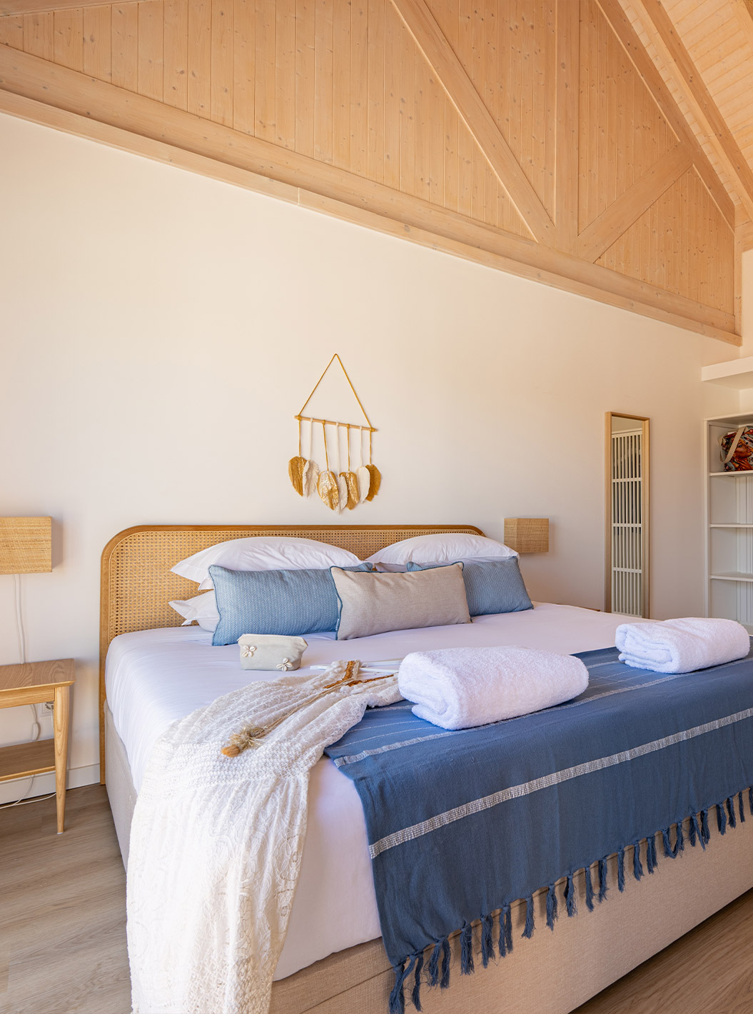The Premium Villa at Pestana Comporta Village Residences has a bedroom with a double bed and several blue pillows