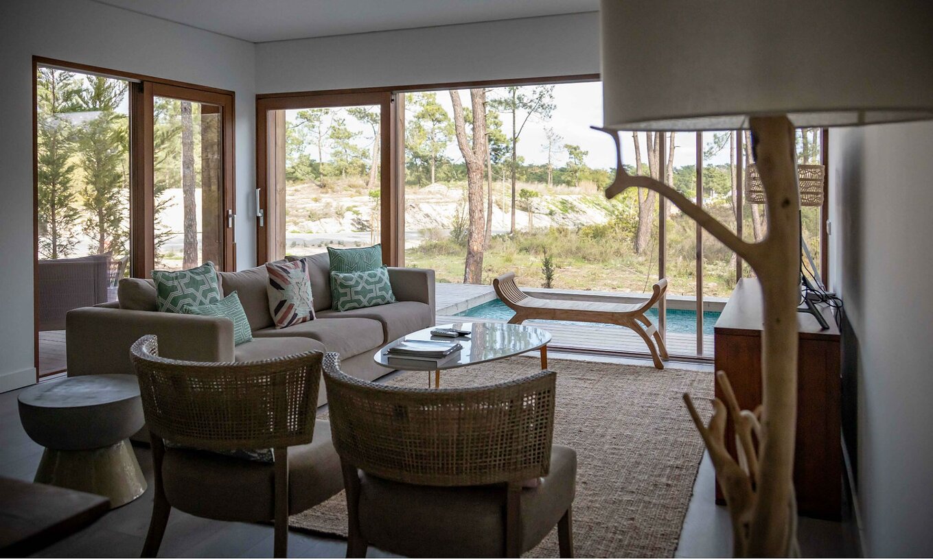 The Eco Village Apartment Ground Floor Views of Pestana Tróia Eco Resort has a room with sofa and view of the private pool