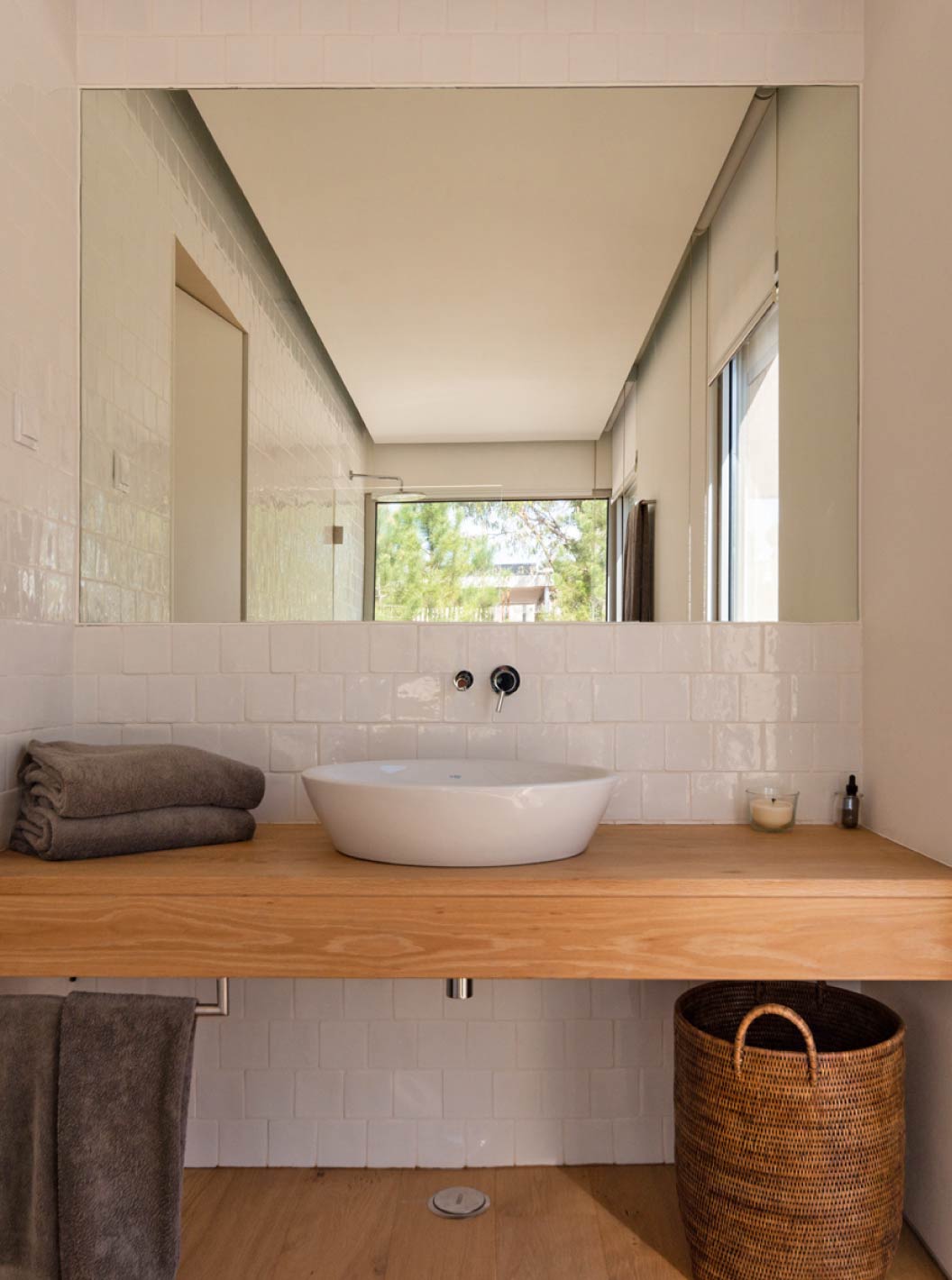 The exclusive villa with a pool at Pestana Tróia Eco Resort has a bathroom with a sink, a wooden counter, and a mirror