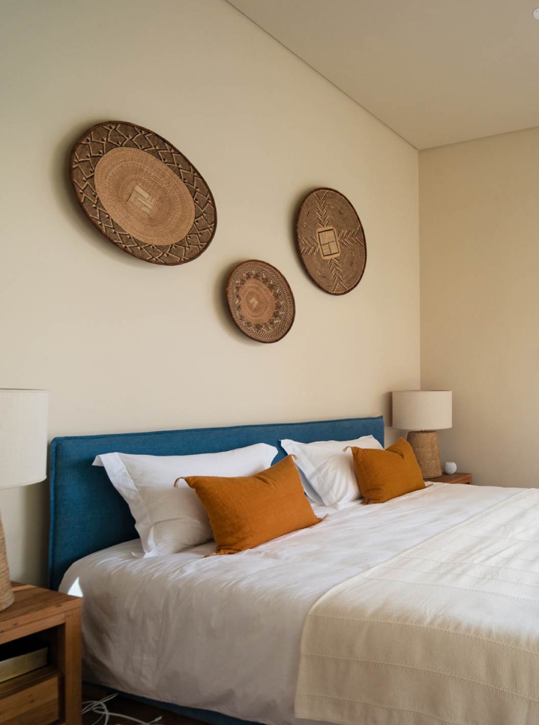 The exclusive villa with a pool at Pestana Tróia Eco Resort has a double bed with orange cushions in front of a window