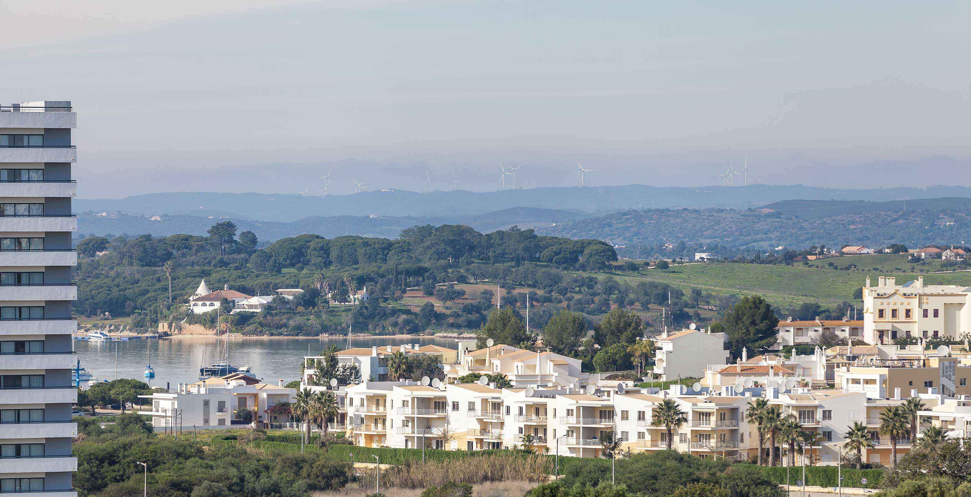 The T1 Garden View Apartment at Pestana Alvor Atlântico has a garden view of buildings and houses around the hotel