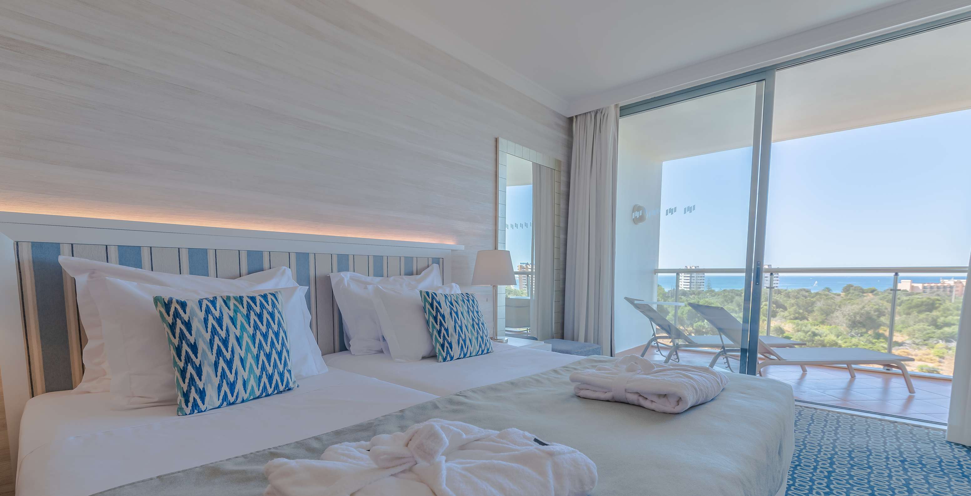 The T1 - with 1 Superior Bedroom at Pestana Alvor Park has two beds with a headboard and a balcony with sun loungers