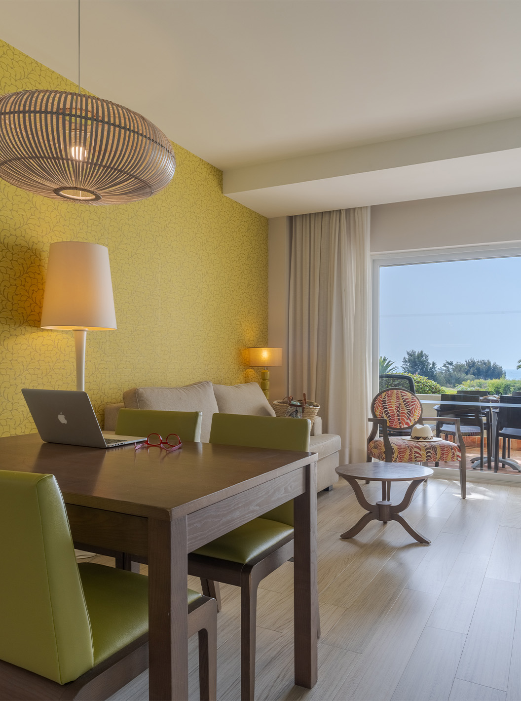 The Duplex Sea View Suite T1 at Pestana Alvor Praia has a living room with a dining table and a balcony