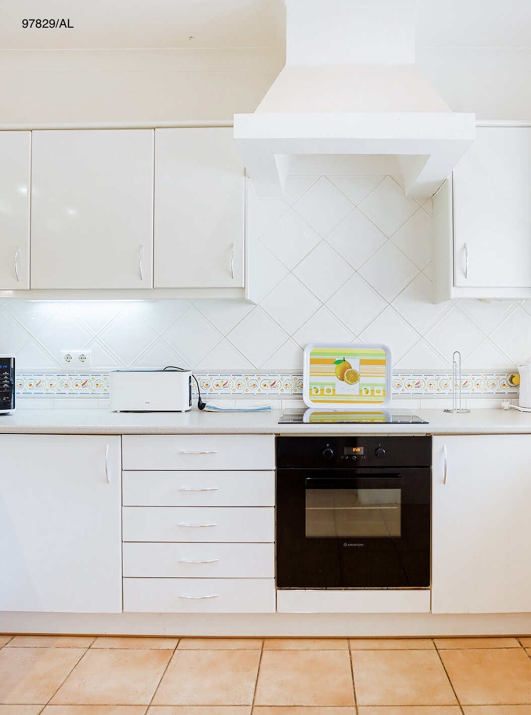 The Pestana Carvoeiro Golf T2 Standard Apartment has a kitchen with white cabinets and a countertop