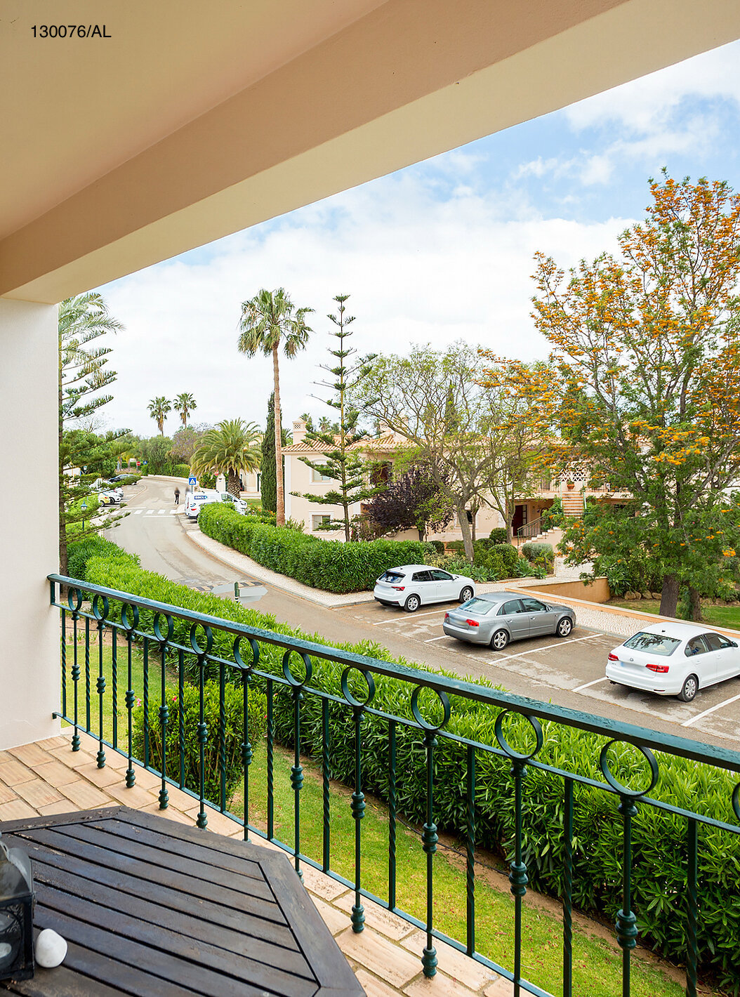 The Pestana Carvoeiro Golf T2 Standard Apartment has a balcony with tables and chairs, with a street view