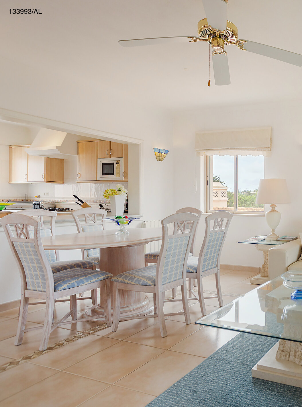 The Pestana Carvoeiro Golf T2 Superior Apartment has a living room with a white sofa, dining table, and six chairs