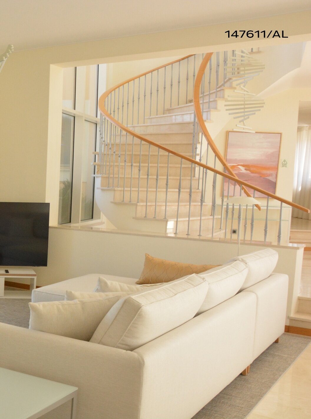 The Pestana Carvoeiro Golf V5 Superior Villa has a living room with a beige sofa, a table, and a TV