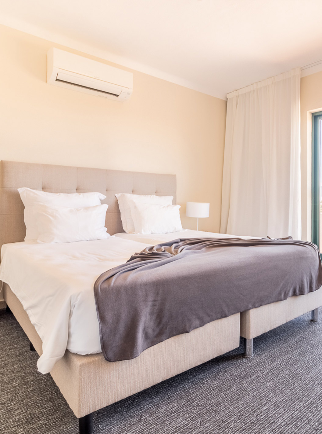 The one-bedroom apartment at Pestana Gramacho has a modern room with large bed, big windows and natural light