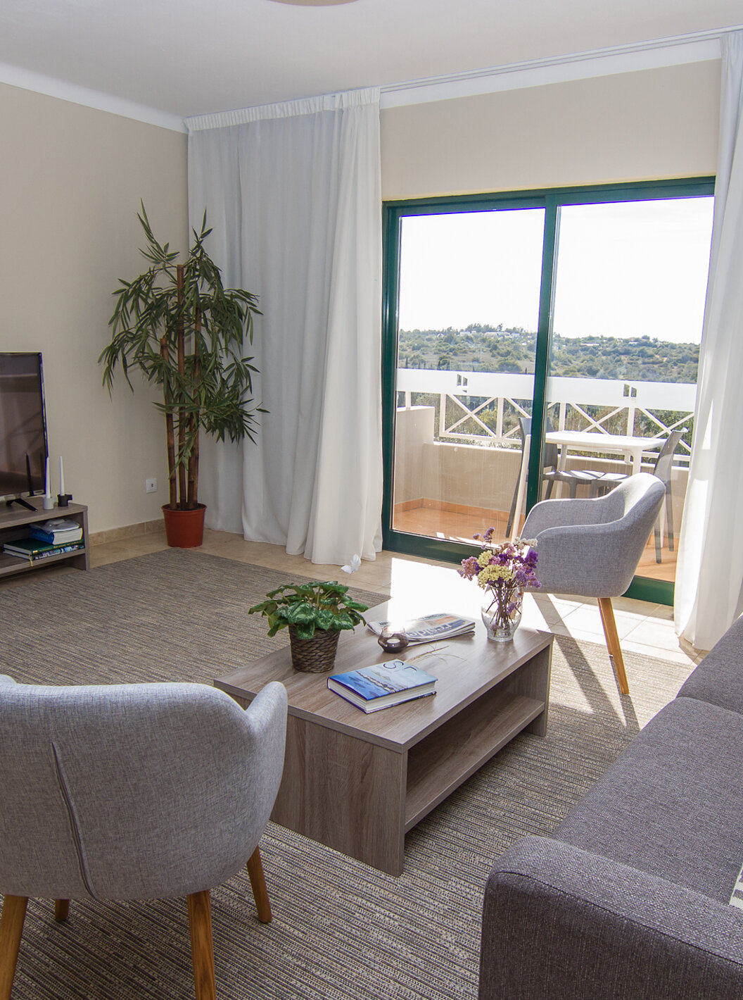 The V3 Villa at Pestana Gramacho Residences includes a living room with sofas, television, and a window with a balcony