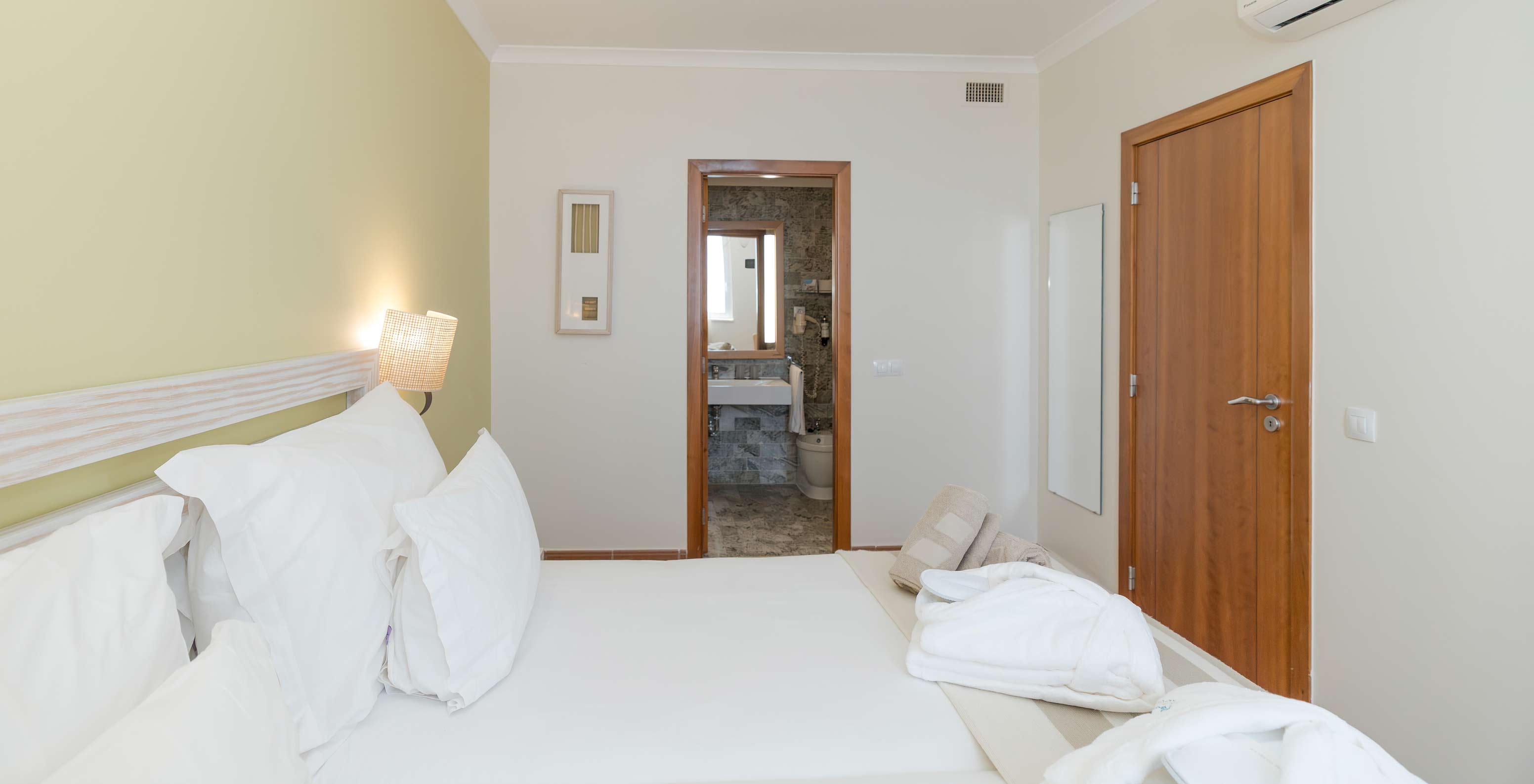 The Sea View Suite at Pestana Viking has two beds with bedside table and a bathroom