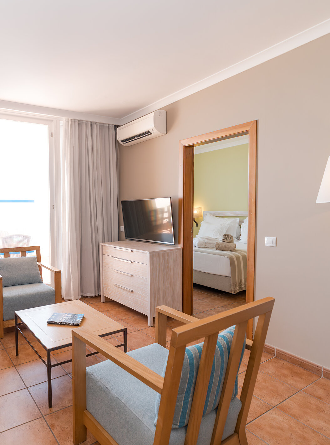 The Sea View Suite at Pestana Viking has a living room with sofa, armchairs, TV, air conditioning and balcony access
