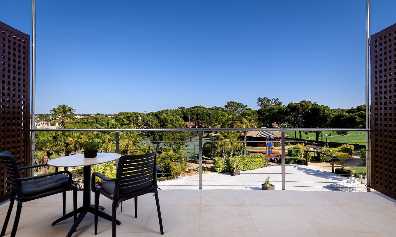 The Superior at Pestana Vila Sol - Vilamoura has a balcony with a table and chairs, and view of a golf course