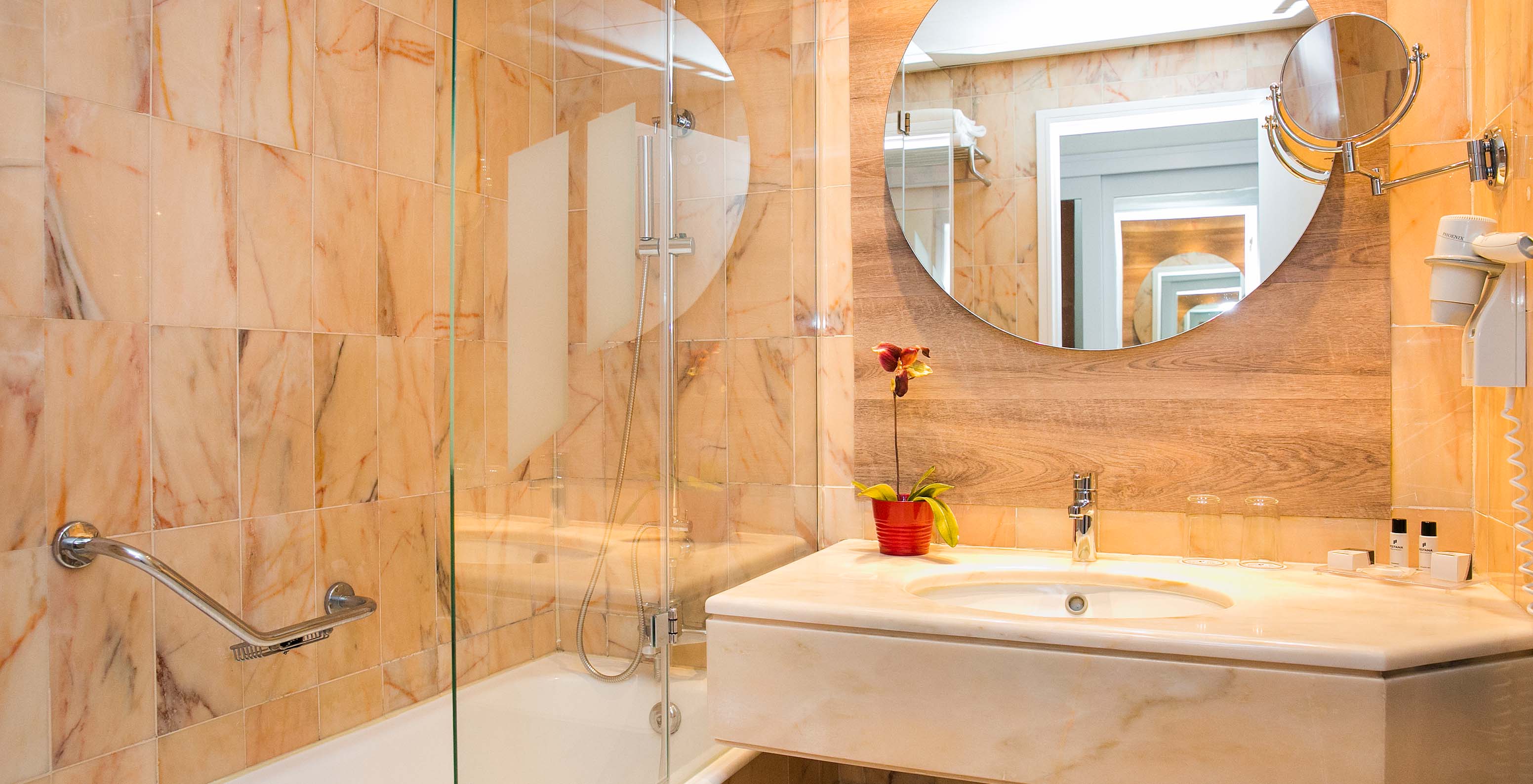 The Deluxe Suite at Pestana Cascais has a bathroom with a mirror, sink, and bathtub with a shower