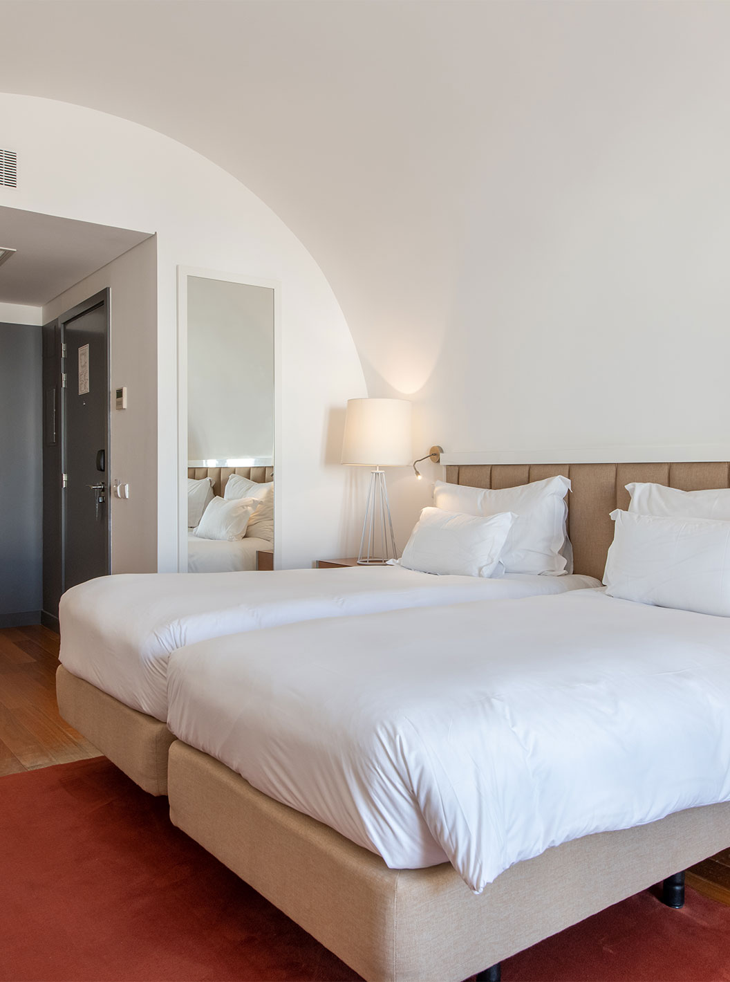 The Classic Room at Pestana Cidadela Cascais has two single beds, a red carpet, and a large mirror