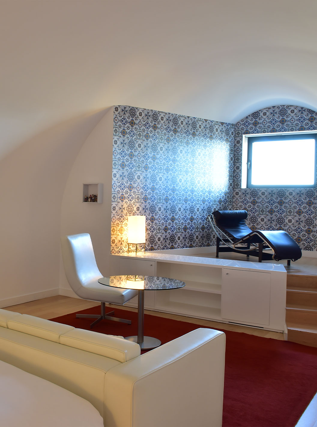 The Junior Suite Art District at Pestana Cidadela Cascais has a coffee table with a chair and a chaise lounge