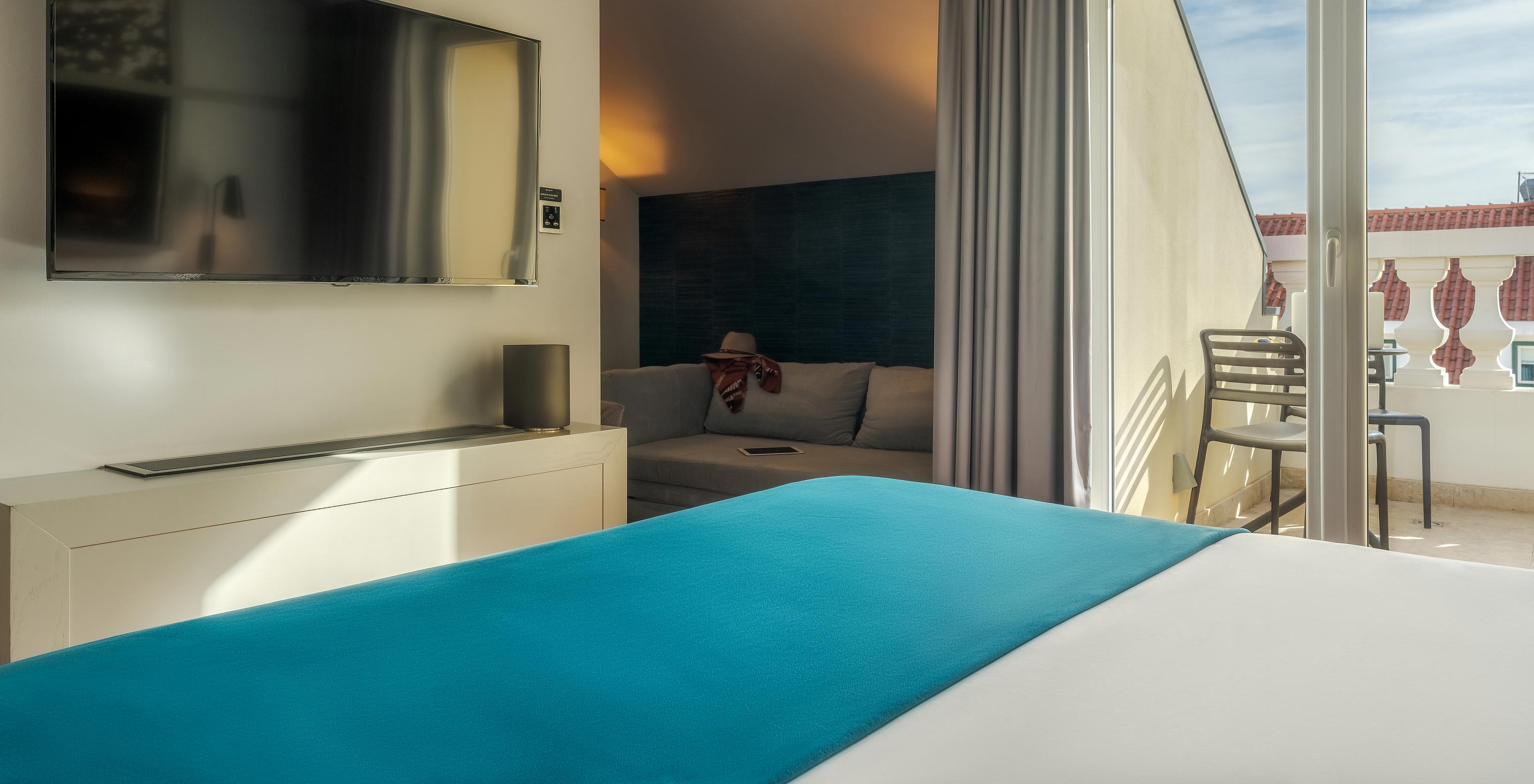 The CR7 Superior Rooftop has a double bed a sofa and a balcony at Pestana CR7 Lisboa