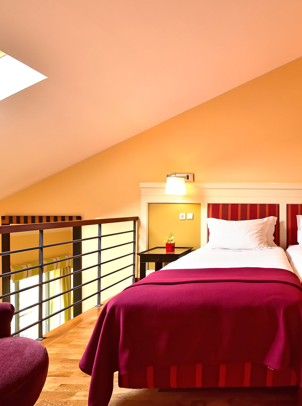 The Family Mezzanine Suite of Pestana Sintra Golf has a mezzanine with two beds, bedside table, wardrobe, and shelves