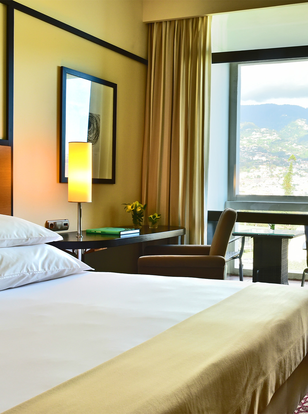 The Classic Garden View room at Pestana Casino Park has a double bed, a TV, a desk, and a balcony
