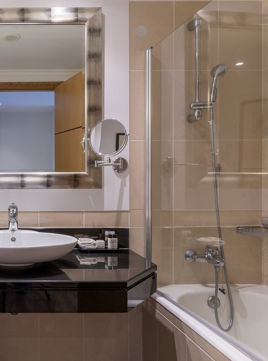 The Classic Inland View Room at Pestana Grand has a bathroom with a sink, bathtub with shower and towel