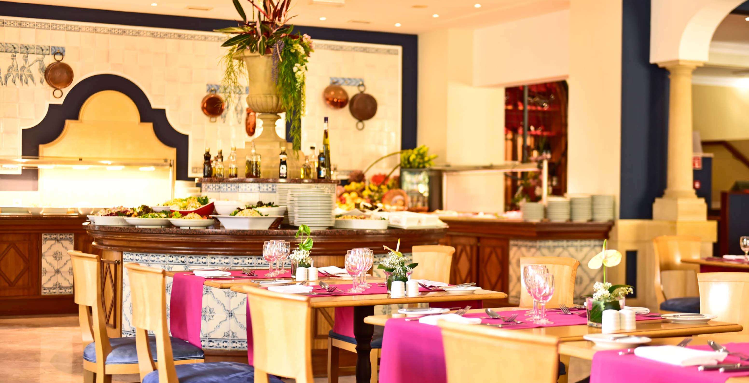 The restaurant A Vila, at the Hotel de Charme in Madeira has several tables and breakfast with a buffet