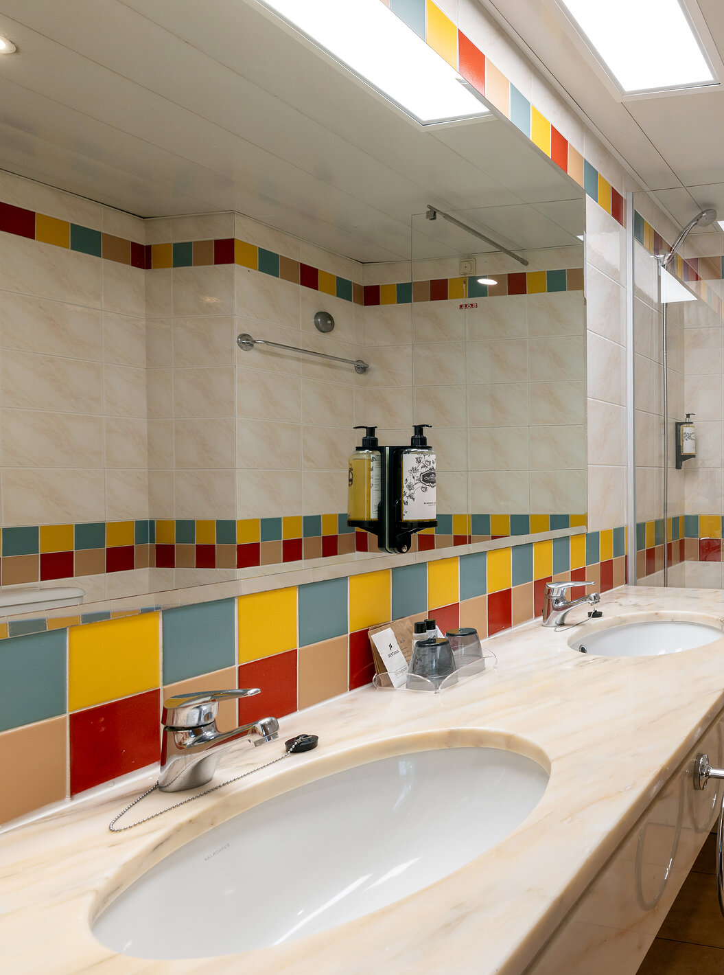 The Pestana Ocean Bay All Inclusive Junior Suite Sea View has a tiled bathroom with a bathtub and two washbasins