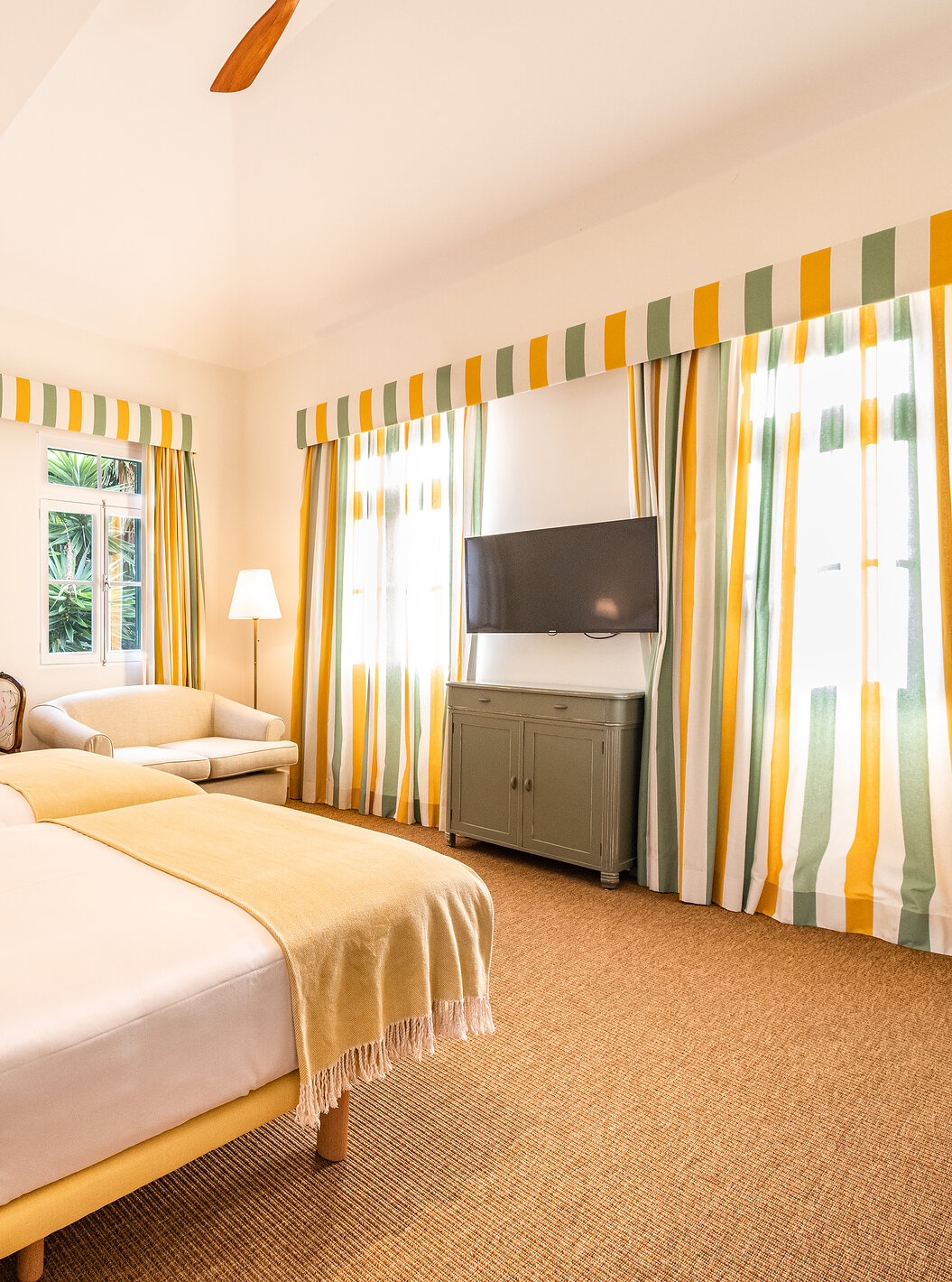 The Manor House - 1 of Pestana Quinta do Arco has two joined beds, sofa, table, television, carpet, and windows with curtains