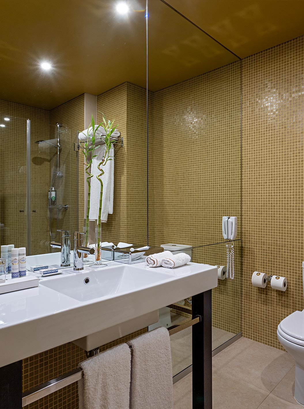 Pestana Palácio do Freixo’s Loft Attic has a bathroom with yellow tiles, toilet and washbasin