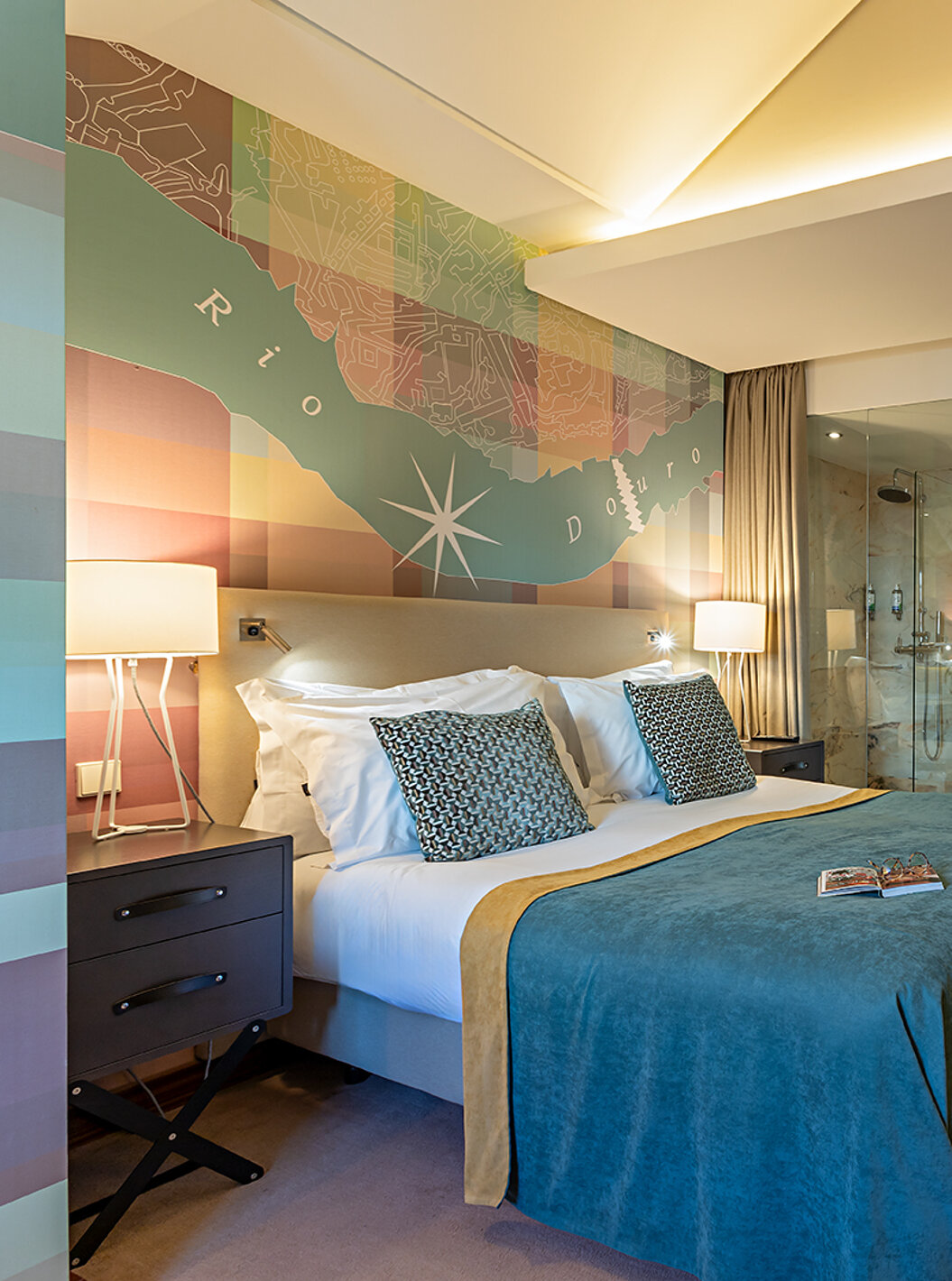 The Classic at Pestana Vintage Porto has a double bed with a blue cover and a desk with a chair