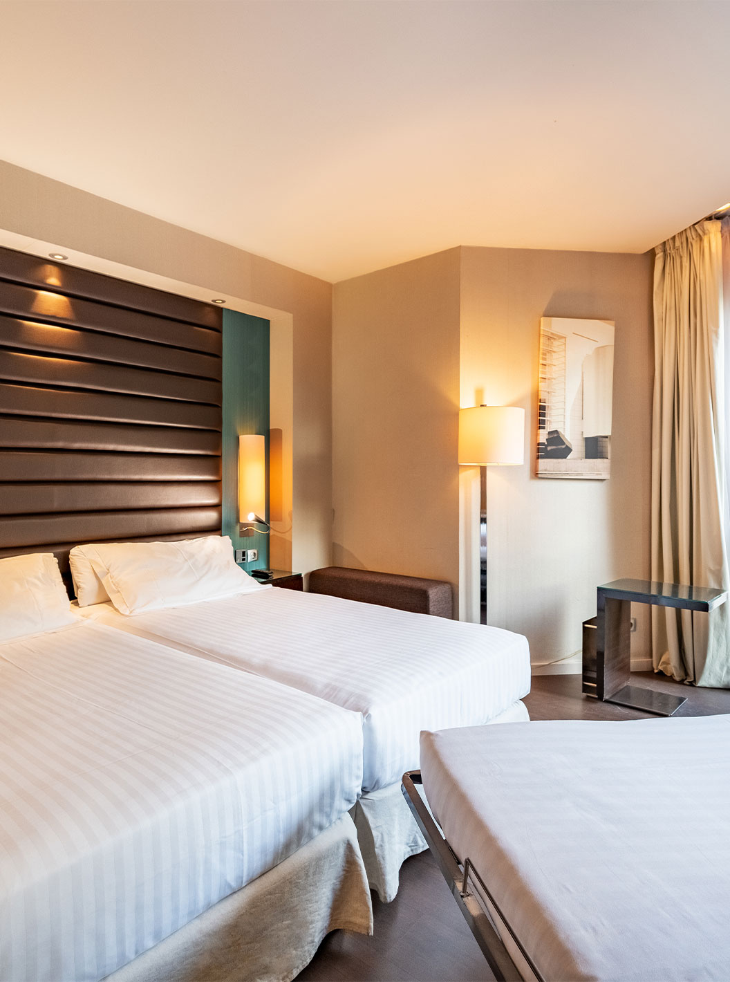 Superior Family room at Pestana Arena Barcelona has a large window, two single beds and an extra bed