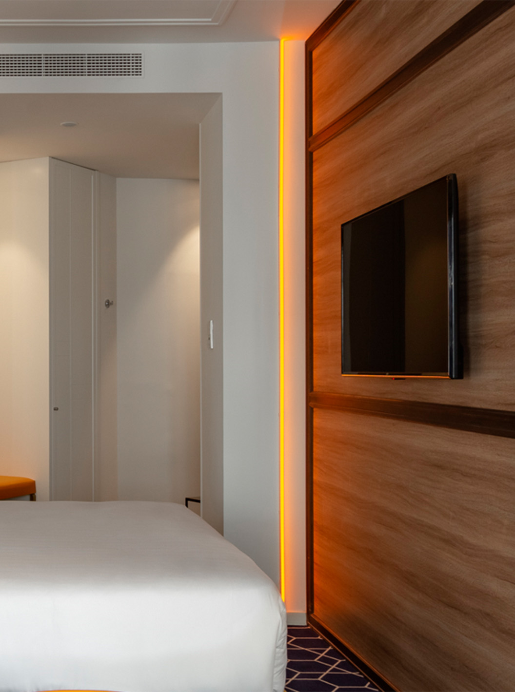 The Amazing CR7 Room at Pestana CR7 Gran Vía Madrid features a double bed, television, hexagonal rug, and entrance door