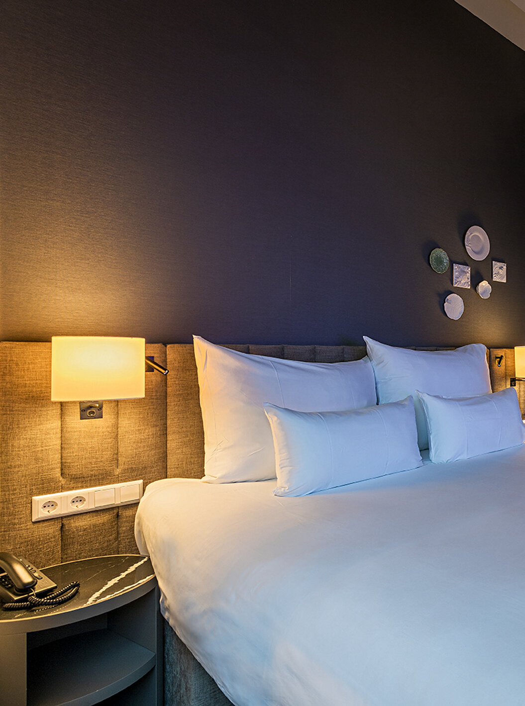 Loft room at Pestana Amsterdam Riverside has a double bed, with bedside table and lamp