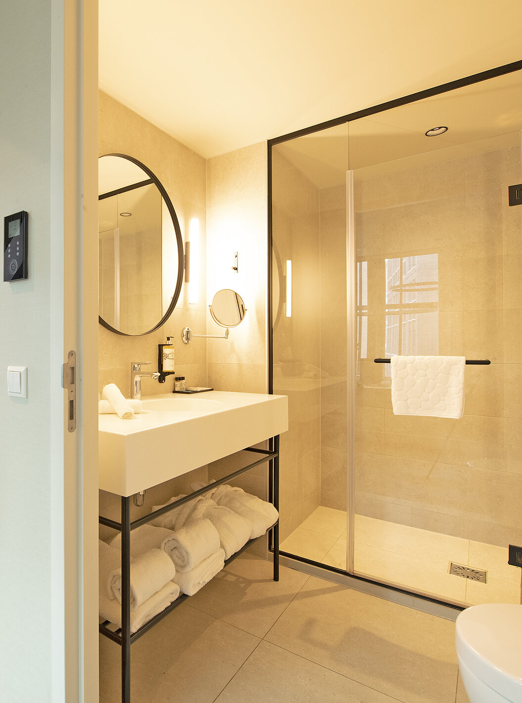 Mezzanine Suite at Pestana Amsterdam Riverside has a bathroom with mirror, sink, towels and shower