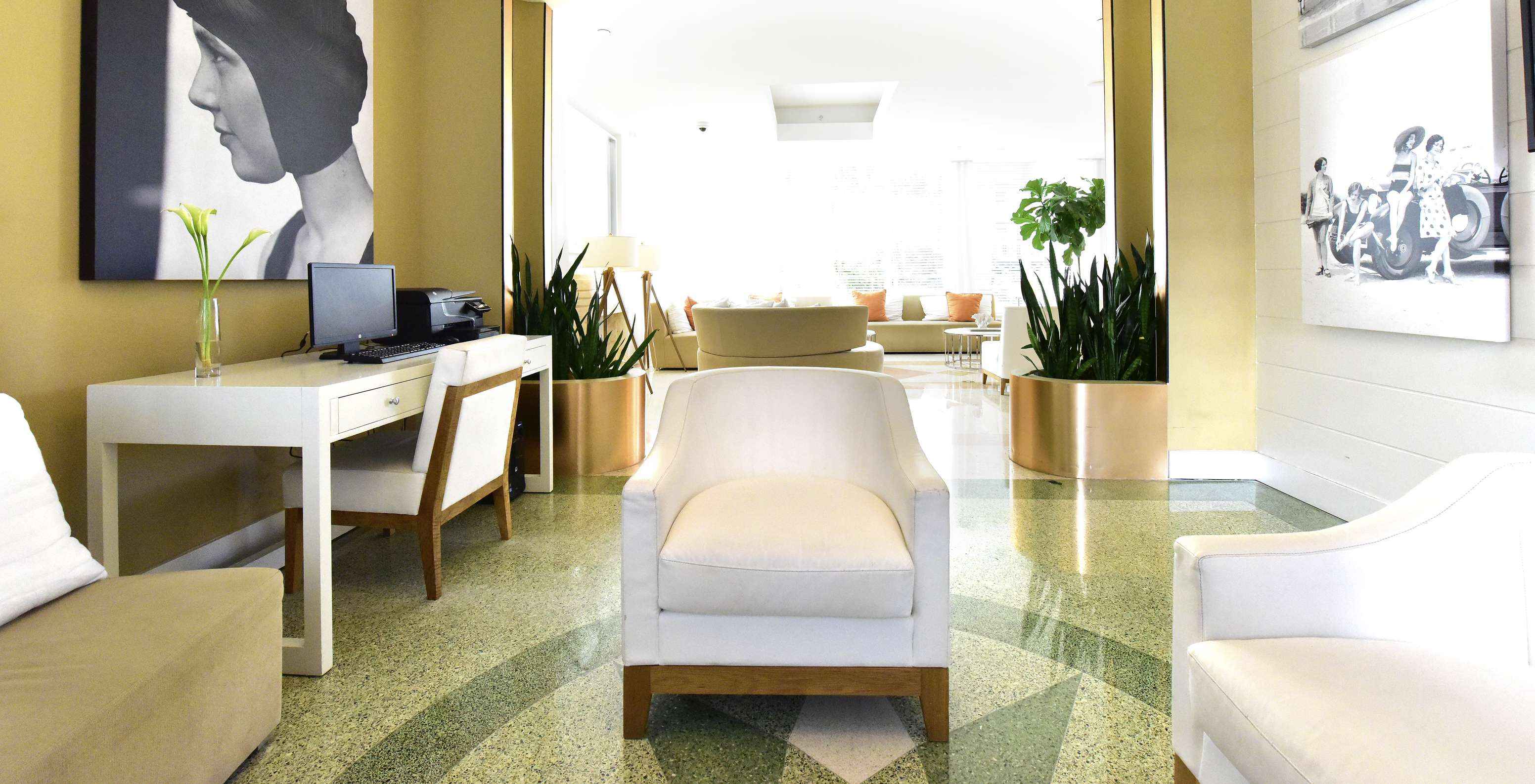 Workspace in the hotel lobby equipped with a computer, photocopier, desk, and chairs