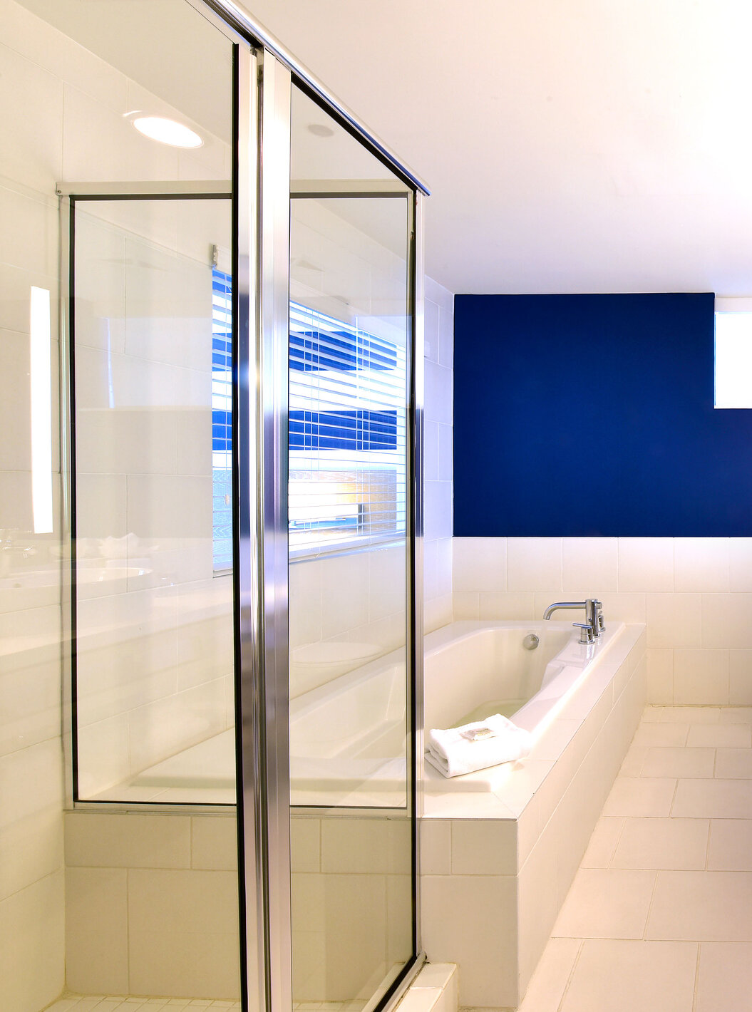 The Two Bedroom Suite with Balcony at Pestana Miami has a modern bathroom with shower and bathtub