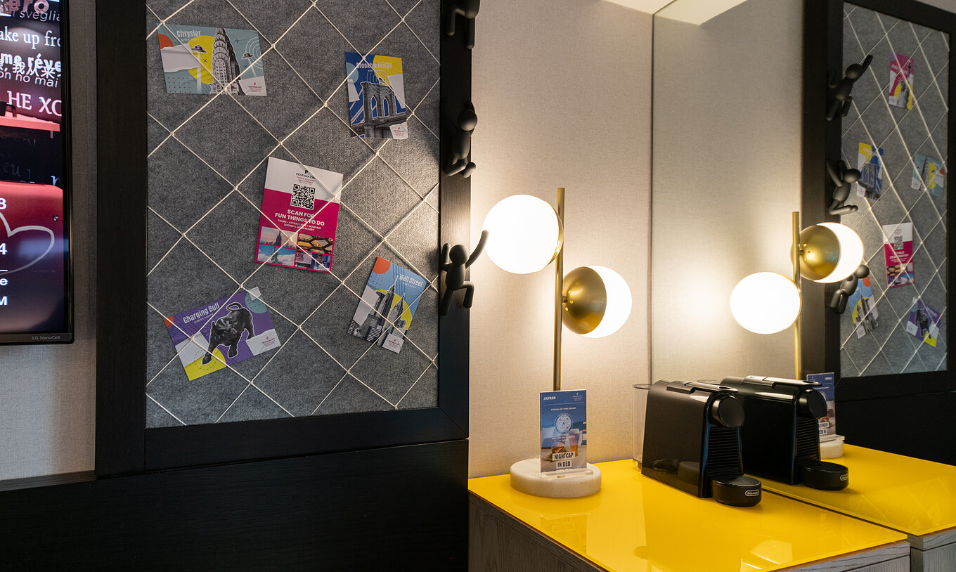 The Superior King High Floor at Pestana CR7 Times Square has a bedside table with a lamp and a mirror