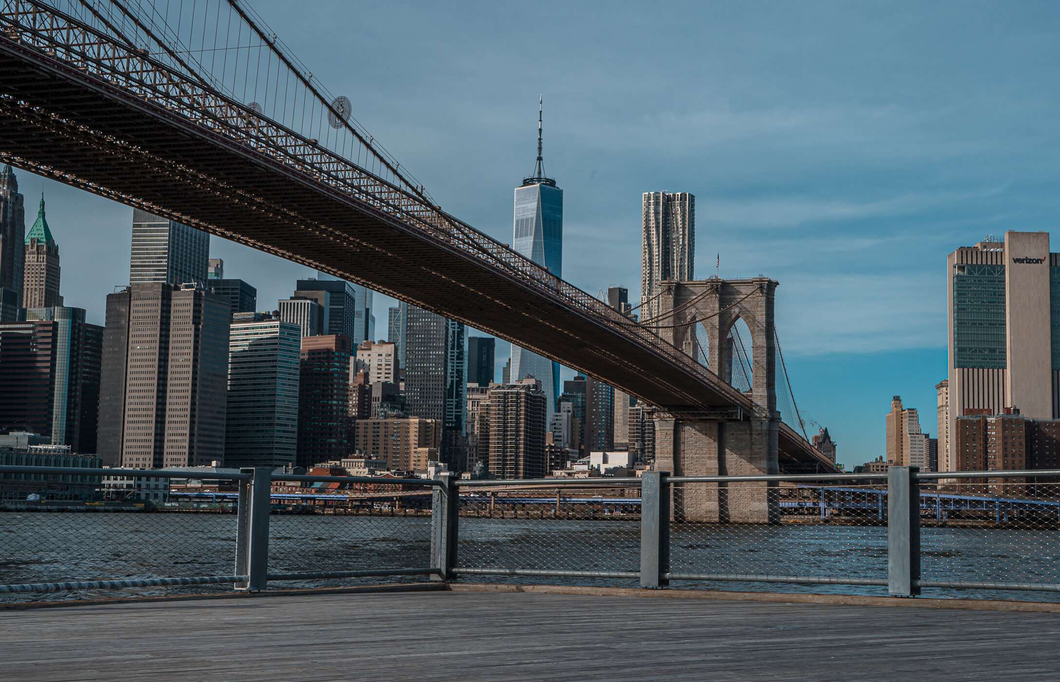 View of the famous Brooklyn Bridge in New York City, USA, over the Hudson River, with the city in the background