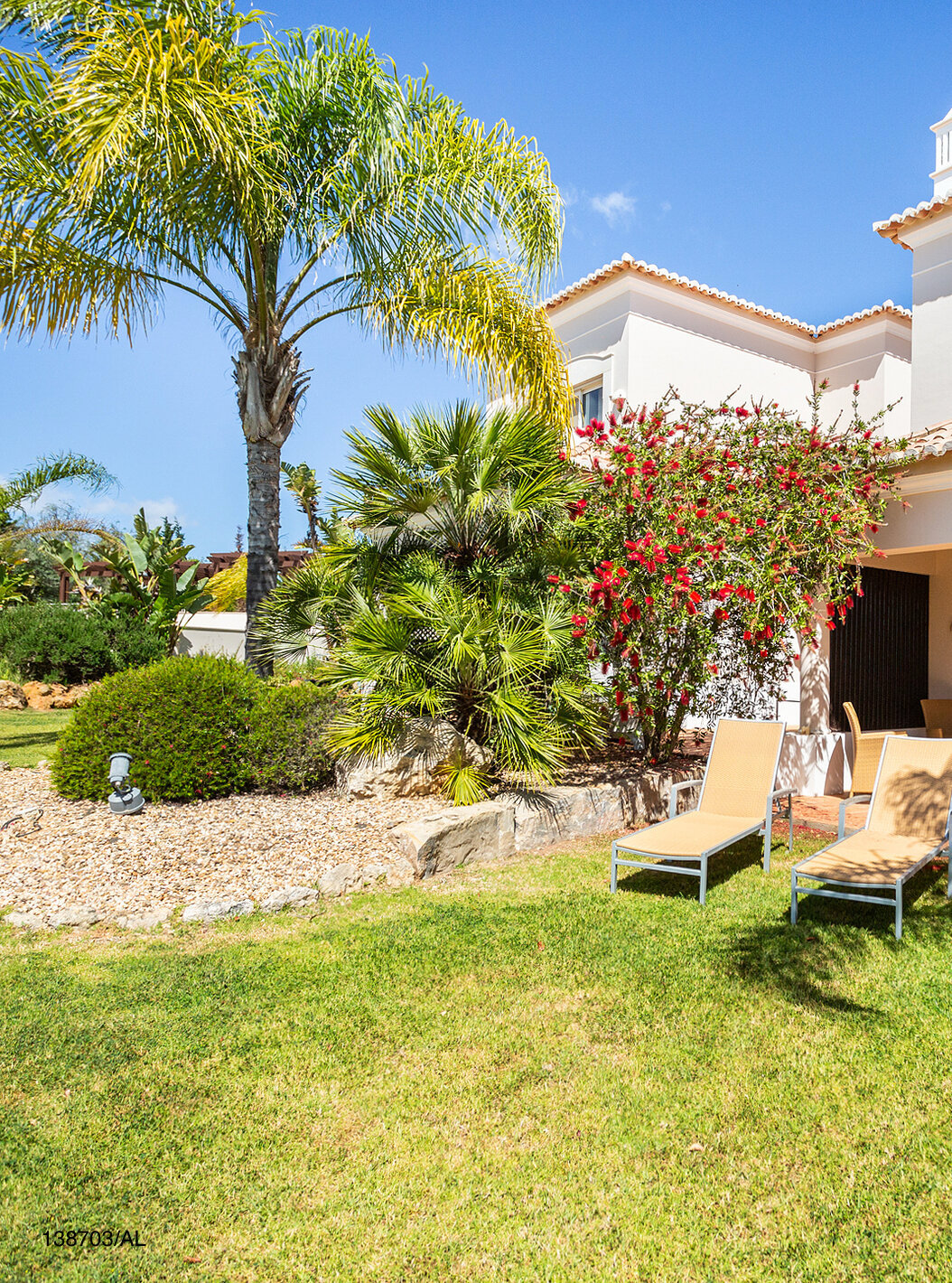 The Pestana Carvoeiro Golf T2 Superior Apartment has an exterior patio with grass and yellow loungers