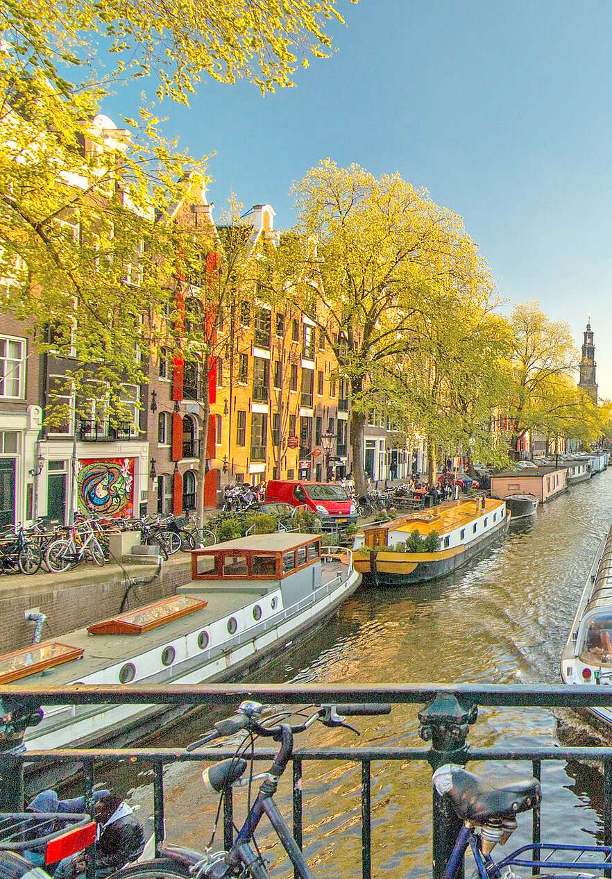 Discover the Netherlands and explore the beauty of Amsterdam's canals and its impressive typical buildings.