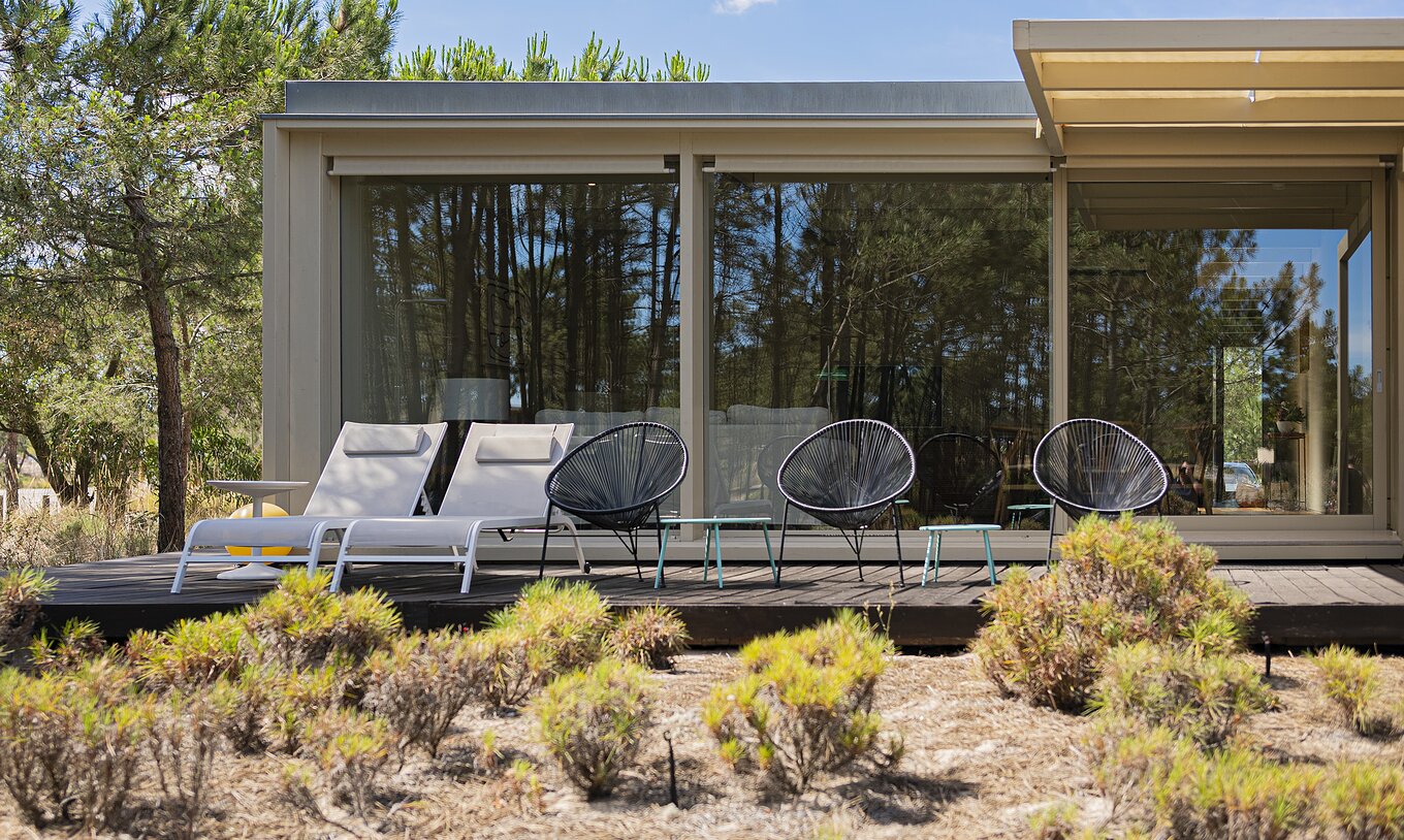 De Townhouse van Pestana Tróia Eco Resort heeft een terras met ligstoelen en drie stoelen