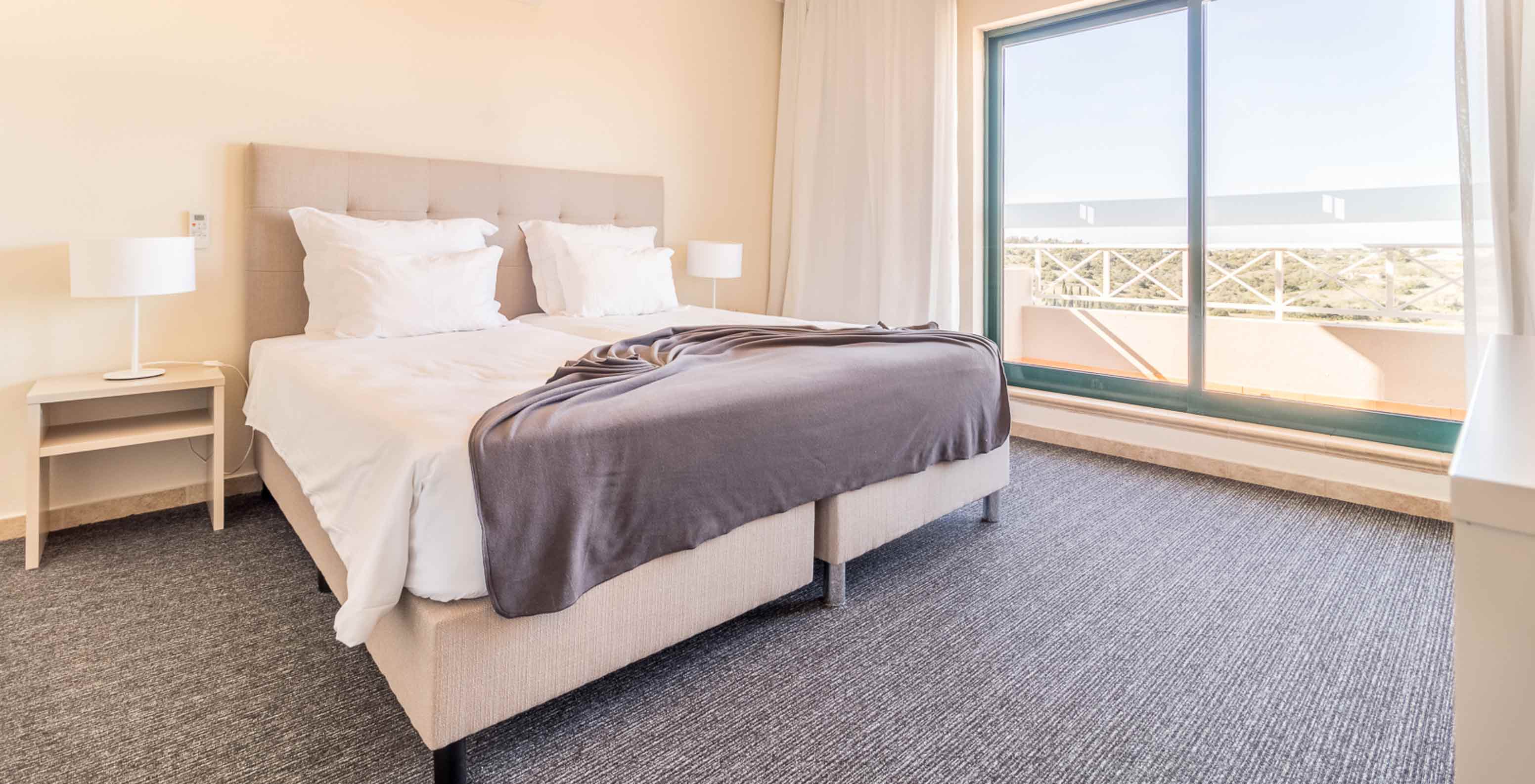 Het éénslaapkamerappartement bij Pestana Gramacho heeft een moderne kamer met groot bed, ramen en daglicht