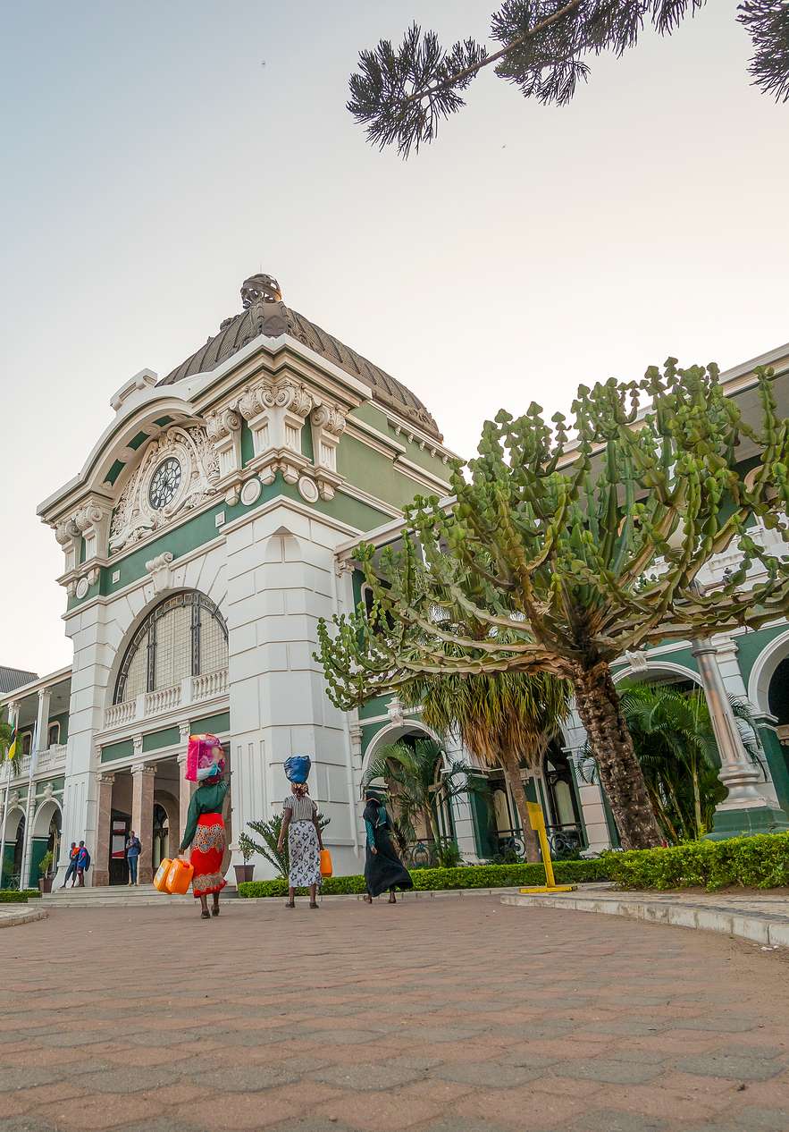 Mensen reizen naar het station van Maputo, een historisch monument met klassieke architectuur en ornamenten
