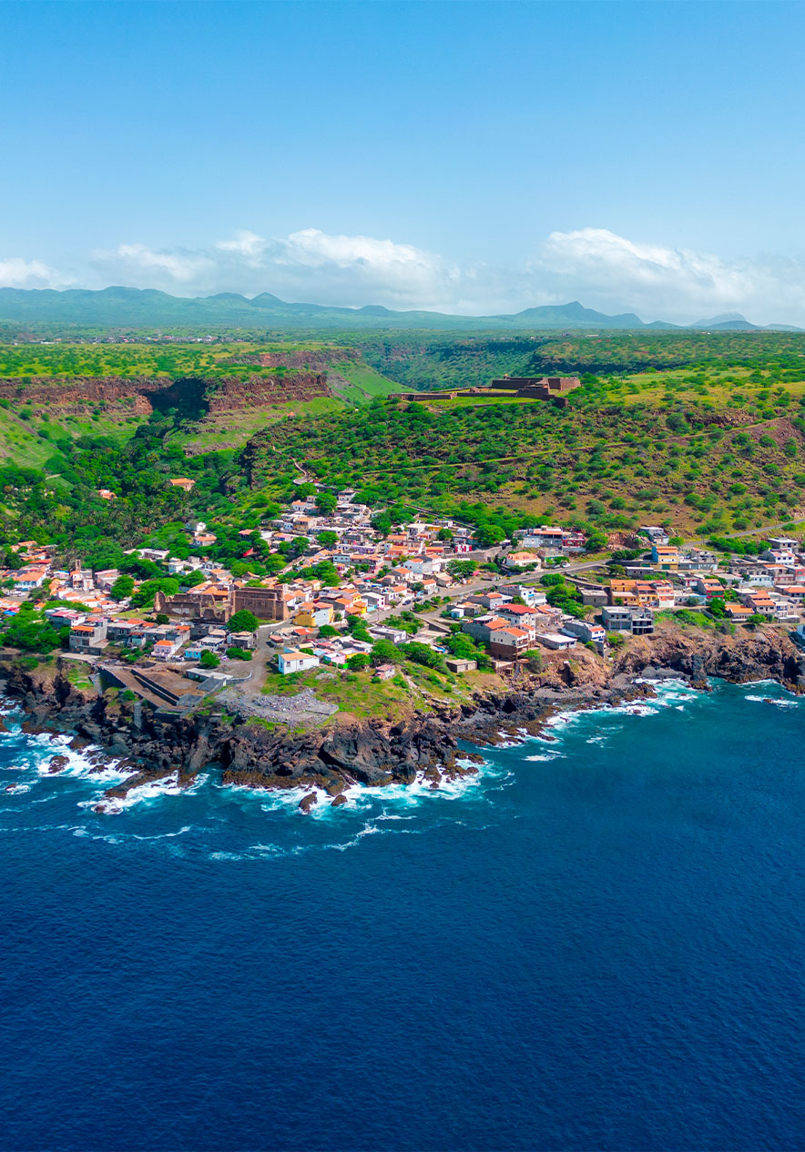 View of Cidade Velha on Santiago Island with the blue sea several houses and intense vegetation in the background