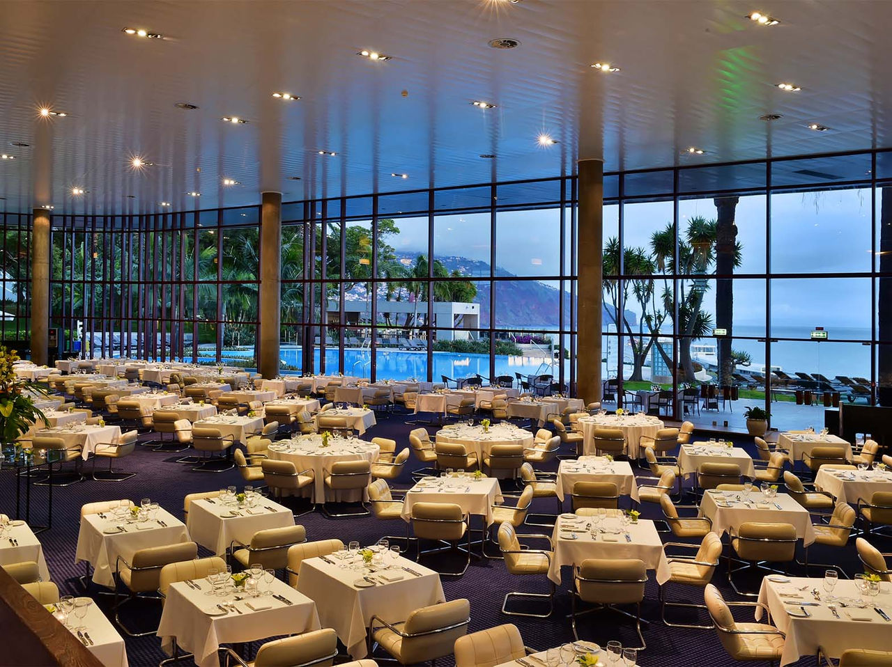 Panorâmico in Funchal offers numerous tables with cushioned beige chairs